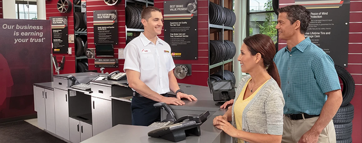 Les Schwab team member working with happy customers