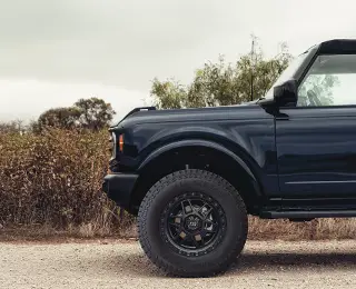 Black SUV on gravel road