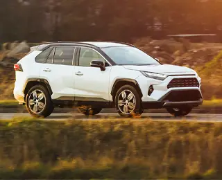 All-wheel-drive (AWD) vehicle travels along scenic roadway