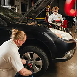 Les Schwab technicians inspecting car